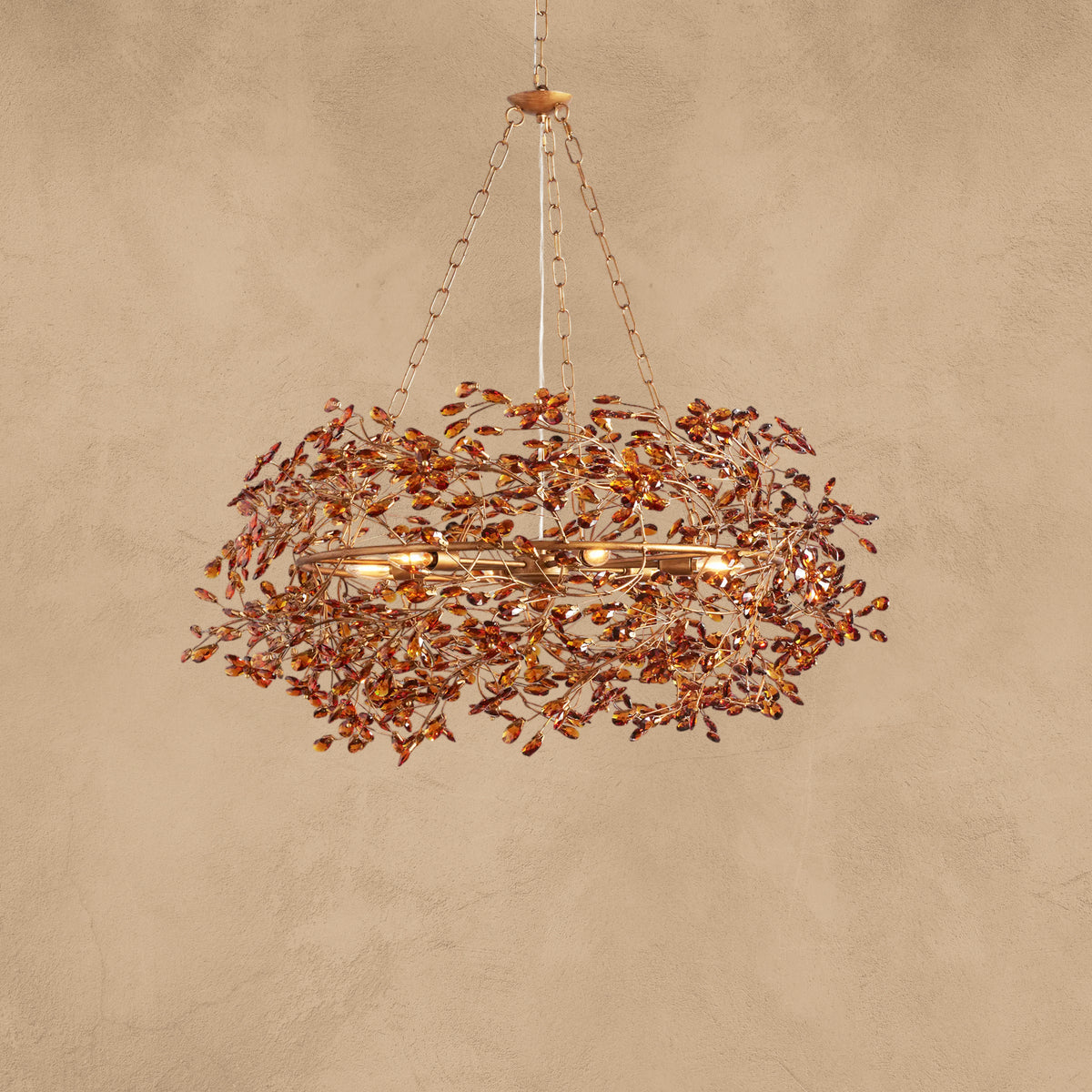 Faverelle chandelier in red-copper finish with crystal blossoms, illuminated