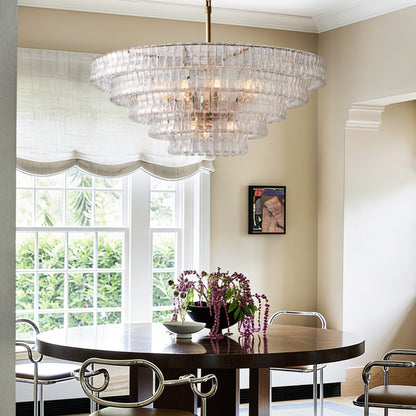 Givrelle round chandelier with clear glass above a dining table in a bright nook