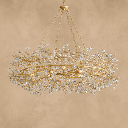 Faverelle chandelier in gold with crystal blossoms, illuminated