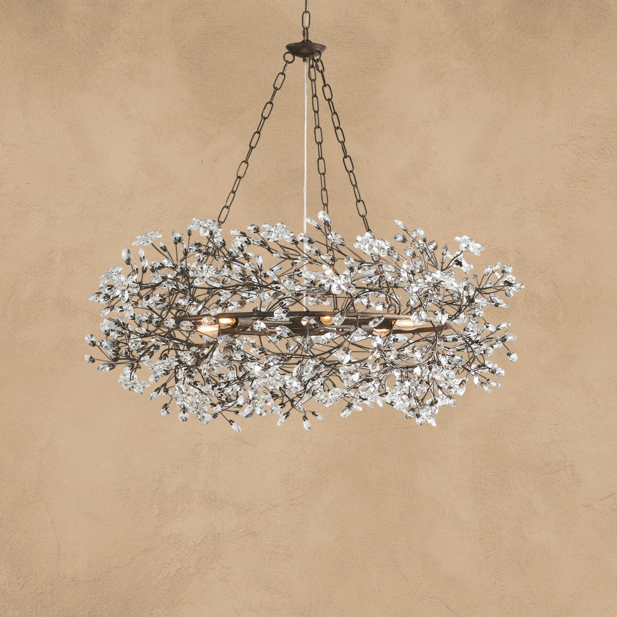 Faverelle chandelier in silver with crystal florals, lit warm