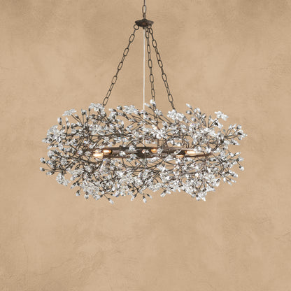 Faverelle chandelier in silver with crystal florals, lit warm