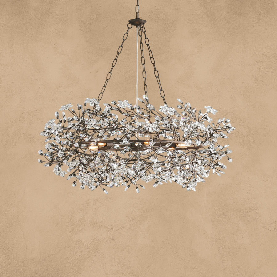 Faverelle chandelier in silver with crystal florals, lit warm