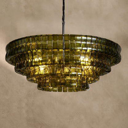 Ghiaccio round chandelier in brass with green glass, illuminated warm glow