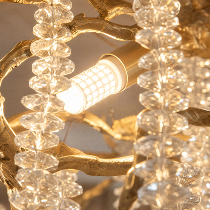 A gold metal branch chandelier with cascading crystal beads suspended in a rainfall arrangement. (3)