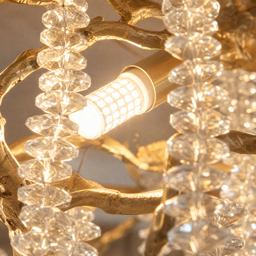 A gold metal branch chandelier with cascading crystal beads suspended in a rainfall arrangement. (3)