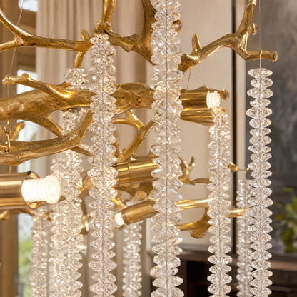 A gold metal branch chandelier with cascading crystal beads suspended in a rainfall arrangement. (4)