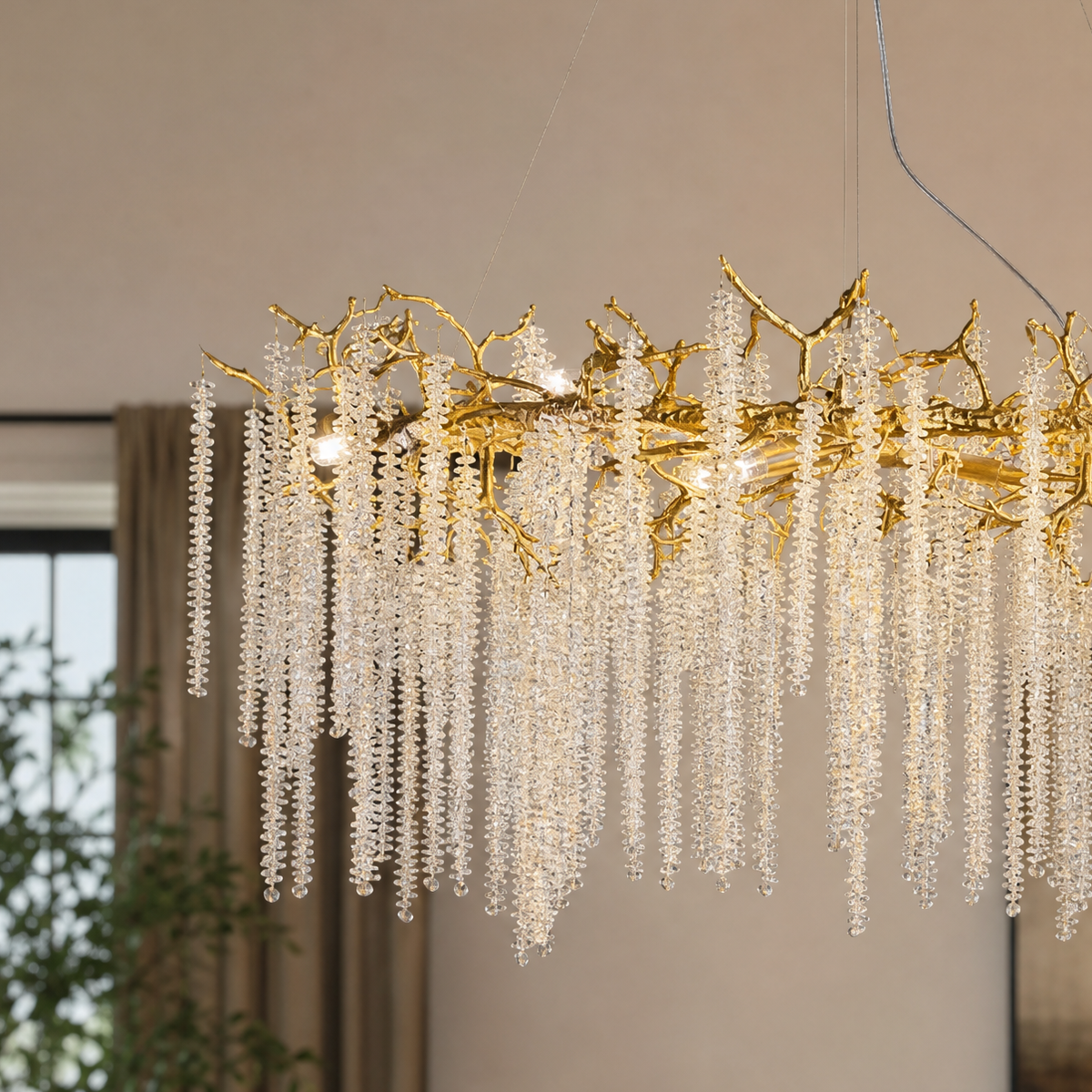 A gold metal branch chandelier with cascading crystal beads suspended in a rainfall arrangement. (2)