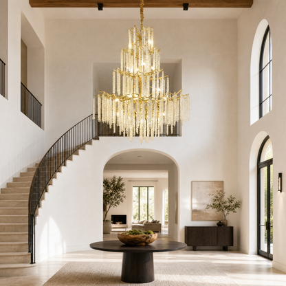 A large, multi-tiered chandelier with a gold branch-like frame and long strands of cascading crystal droplets.