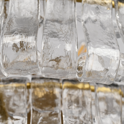 Givrelle round chandelier macro of clear textured ice glass around a warm bulb