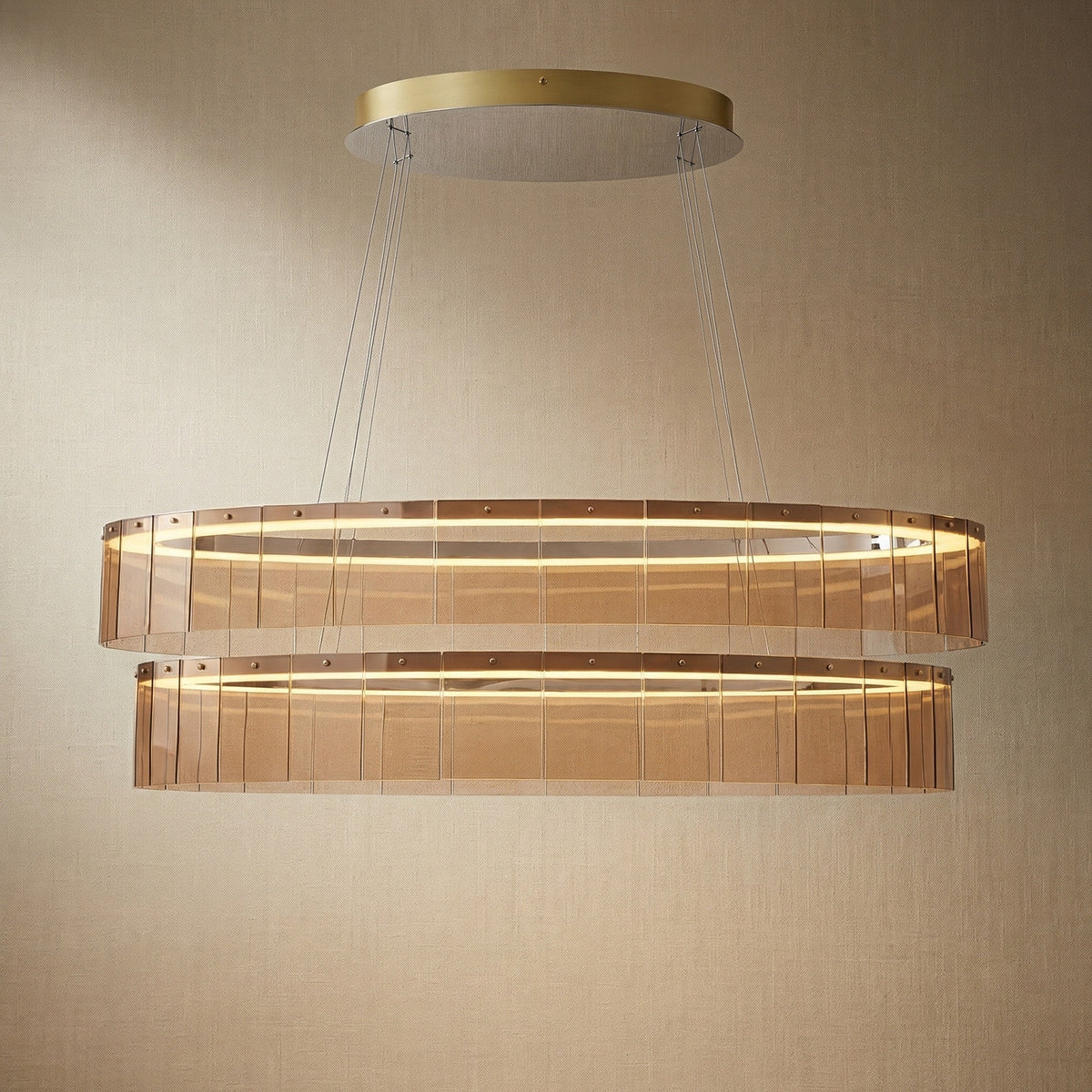 Modern dining room with 59 inch oval glass chandelier over long rectangular table — Yiosi Astor linear pendant